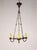 A simple Tudor-esque iron ring chandelier from the early 20th century. It is understated in its simplicity yet eye-...