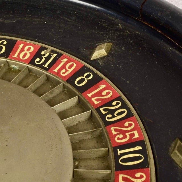 Vintage French Roulette Wheel. Crafted with a beautifully aged black outer bowl and a solid metal central spindle, this...