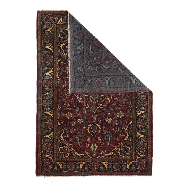 A navy medallion with eight major arabesque-defined points and acanthus pendants, is set on the darkest wine field alive...