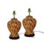 The lamps feature the iconic tortoiseshell texture, showcasing swirling patterns of dark brown, caramel, and beige. The...