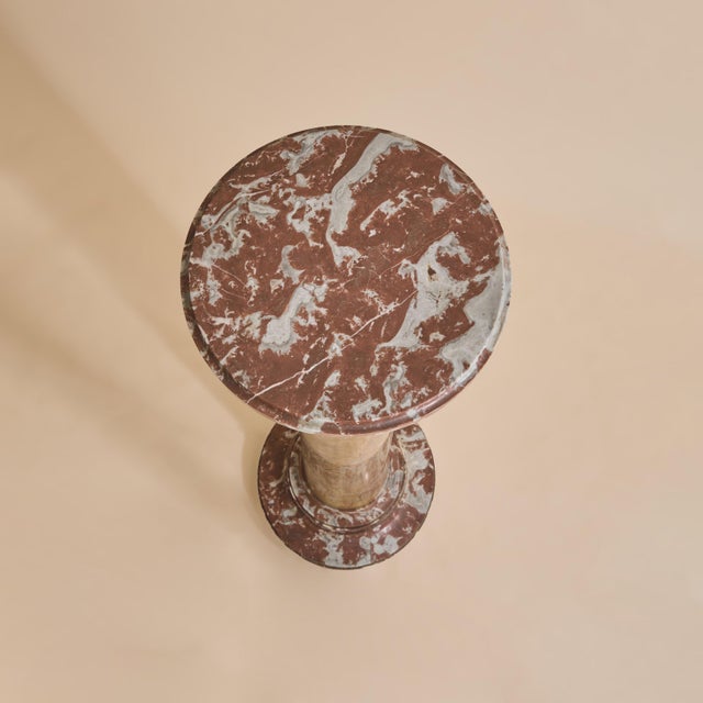 A 19th century French marble pedestal composed of a cylindrical shaft in golden ochre marble, softly veined with muted...