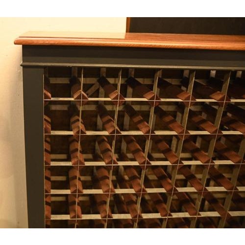 A large and highly practical wine rack cabinet, designed to store and organise a substantial collection of bottles. This...