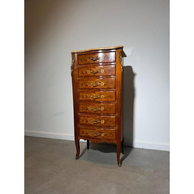 Elegant Louis XV style tall chest of drawers, featuring decorative floral marquetry, brass ormolu mounts and a beautifully...