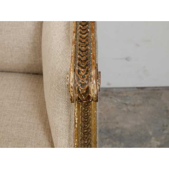 French 19th Century Louis XVI Style Giltwood Wingback Settee with Carved Motifs For Sale - Image 9 of 10