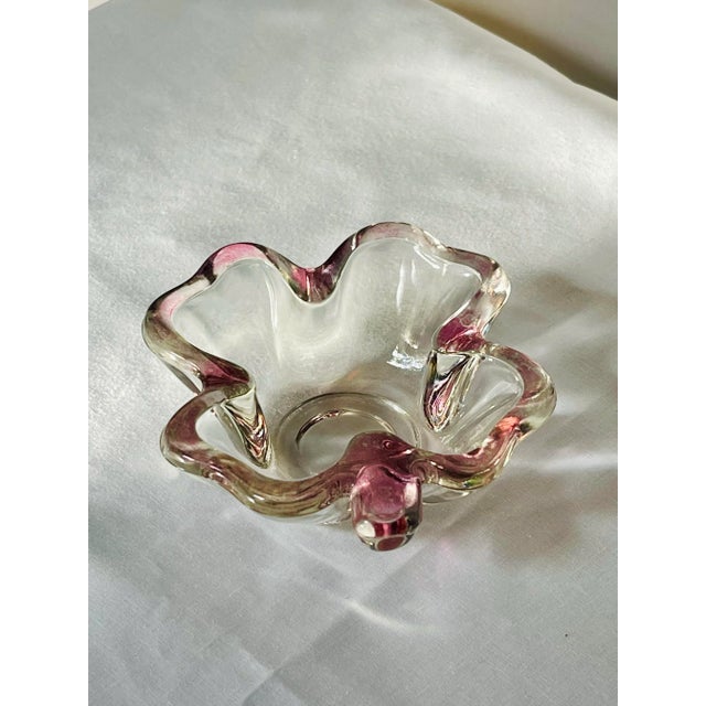 A clover shaped transparent glass trinket dish made by the Federal Glass Company in Columbus, Ohio.