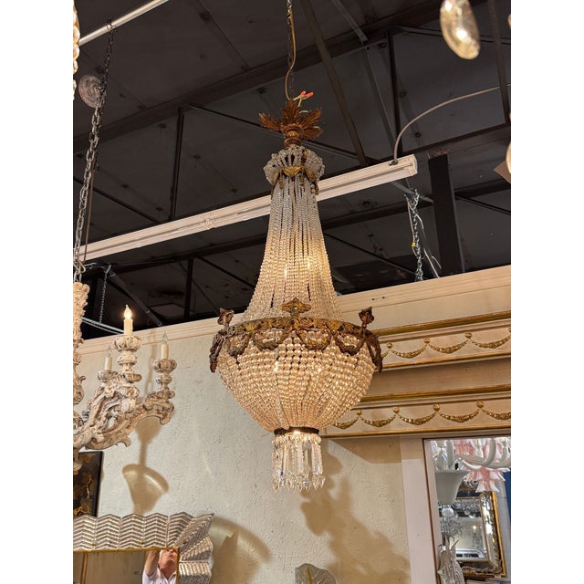 The 19th Italian Gilt Bronze and Crystal Basket Chandelier is a luxurious and elegant lighting fixture . This chandelier...