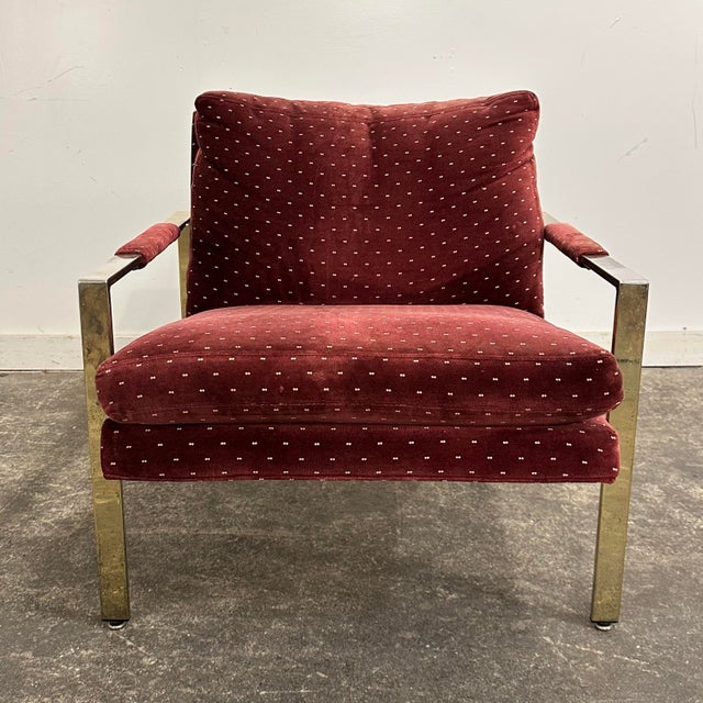 This is a Milo Baughman for Thayer Coggin 951 flat bar lounge chair with a brass coated frame and maroon velvet upholstery.