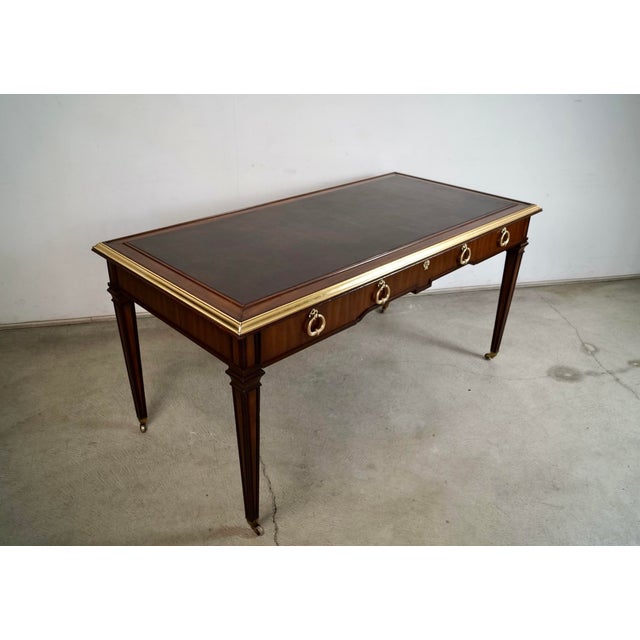 Vintage 1960's Hollywood Regency writing desk for sale. The leather inlay has been resurfaced and has a new leather top in...