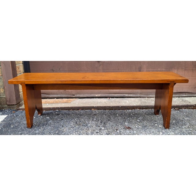 A 20th Century Early American Style Stained Fruitwood Bench . Seat three comfortably. Measures 42" in width, 12" in depth...