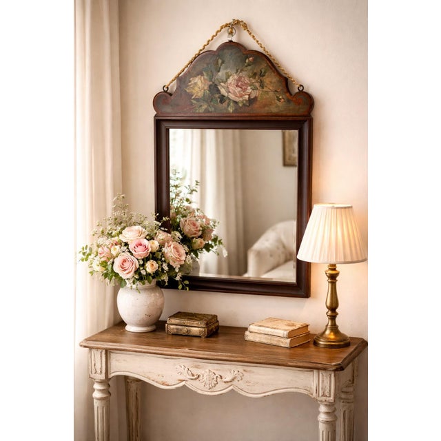 Sight of mirror W15” x H 23.25” A charming vintage wall mirror featuring a hand-painted floral crest with softly rendered...