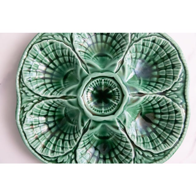 A lovely antique French Sarreguemines majolica oyster plate in gorgeous green, circa 1930. Maker's mark on reverse. It...