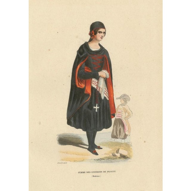 This elegant hand-coloured lithograph depicts a woman from the Prague region in Bohemia, dressed in traditional attire...
