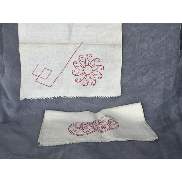 An amazing antique textile find, this set of 2 woven linen towels have hand embroidered details in red embroidery thread...