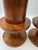 Pair of West Elm solid wood candlesticks featuring a sculptural turned spool form in a rich walnut-tone finish. Clean...