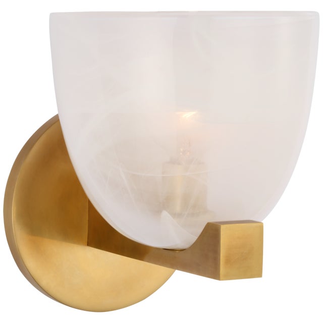 Carola Single Sconce in Hand-Rubbed Antique Brass with White Strie Glass Designer: AERIN Height: 7.25" Extension: 7"...