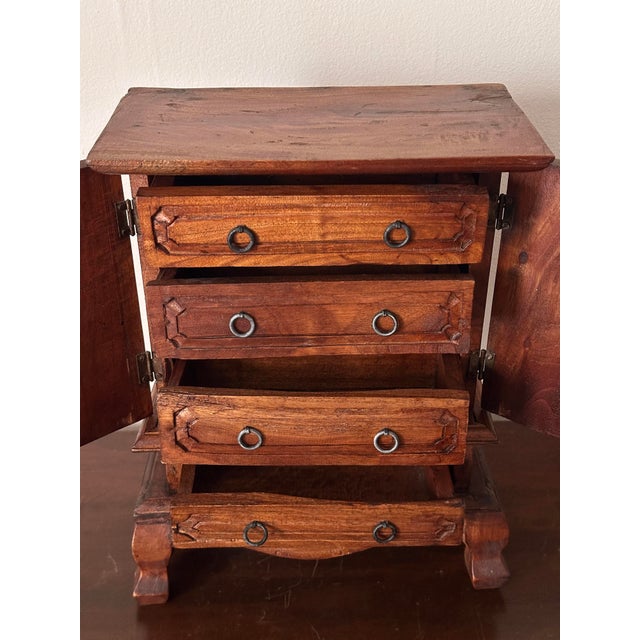 Handmade and carved jewelry armoire likely mango or teak wood. This is also probably originally from Bali but there are no...