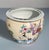 A vibrant hand‑painted fishbowl featuring colorful florals around the exterior and three lively koi swimming among aquatic...