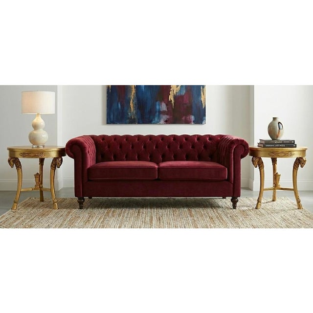 This is a pair of mid-century carved Giltwood side tables with Neo-classical styling. Each table is appointed with rams...