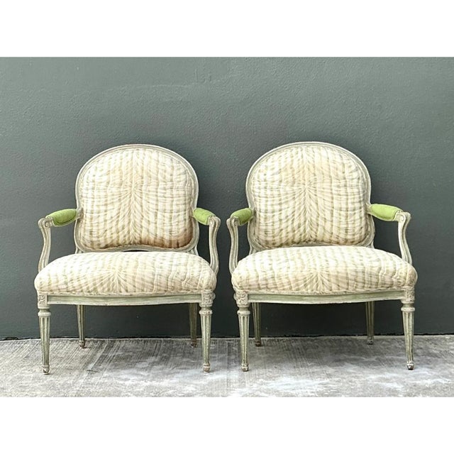 This pair of vintage Louis XVI style armchairs brings French neoclassical grace to a soft, sage-painted frame. Each chair...
