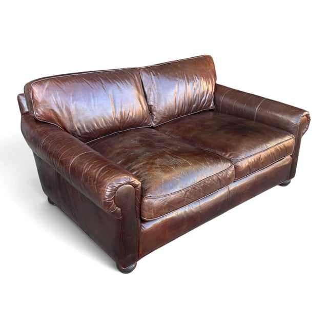 This generously sized Restoration Hardware leather sofa combines classic styling with inviting comfort. Upholstered in...