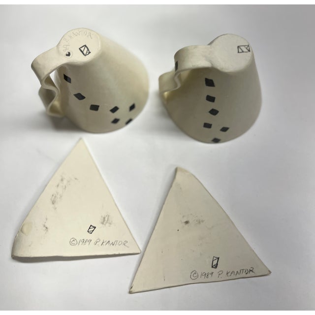 Charming artist made studio pottery Art Deco design of black on white. Cup and saucer sets (2). Signed on bottom "P....