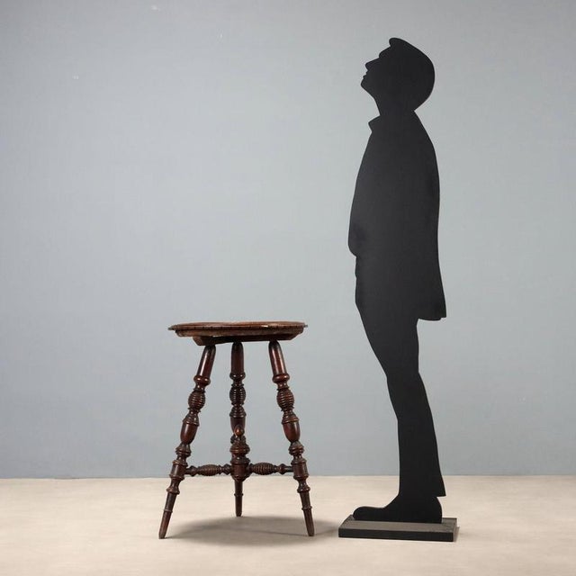 Swiss pine side table dating back to the first half of the 20th century, featuring a black marble inset top. The top is...