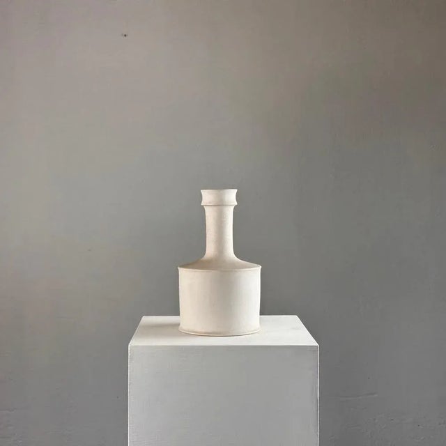 Crafted in the 1960s, this exquisite vase embodies the essence of minimalist sophistication, boasting clean lines and a...