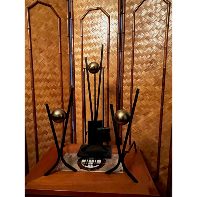 Set of Donald Deskey fireplace tools and andirons manufactured by Bennett MFGA. The wrought iron pieces have cast brass...