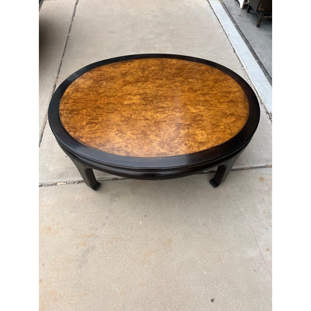 Stunning mid-century Ming-style coffee table featuring an ebonized black lacquer finish and a striking book-matched...