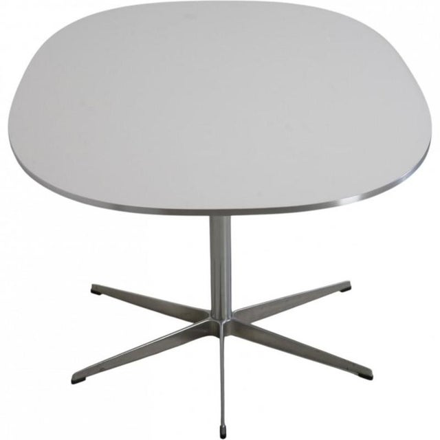 Piet Hein Super ellipse table with a white laminated tabletop and a star base of chrome steel. The table is from 1986 and...