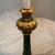 Add timeless elegance to your space with this beautiful pair of table lamps featuring a rich green base accented with...