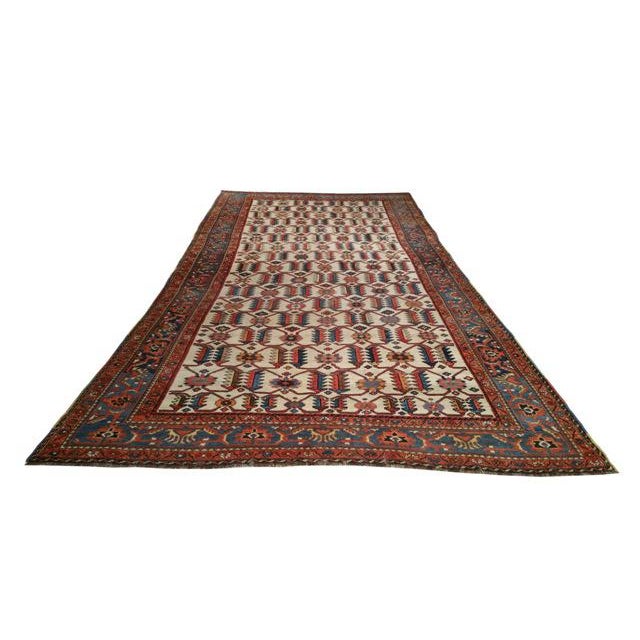 Infuse a touch of beauty to high-traffic areas of your home with this durable Vintage Persian rug in colors of orange,...