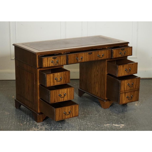 Vintage Oak Office Pedestal Desk with a Brown Leather Top. A classic and elegant piece of furniture that exudes timeless...