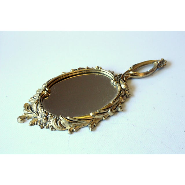 Elegant brass hand held mirror - in excellent vintage condition width approx. 10.83" - depth approx. 4.92" - height...