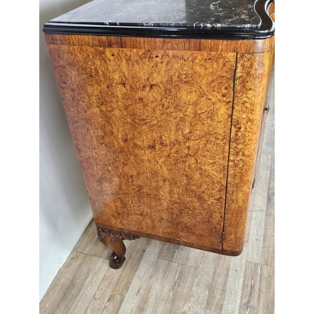 Antique sideboard of the early 1900s in wooden root with double door and central drawer. The furniture is chippedale...