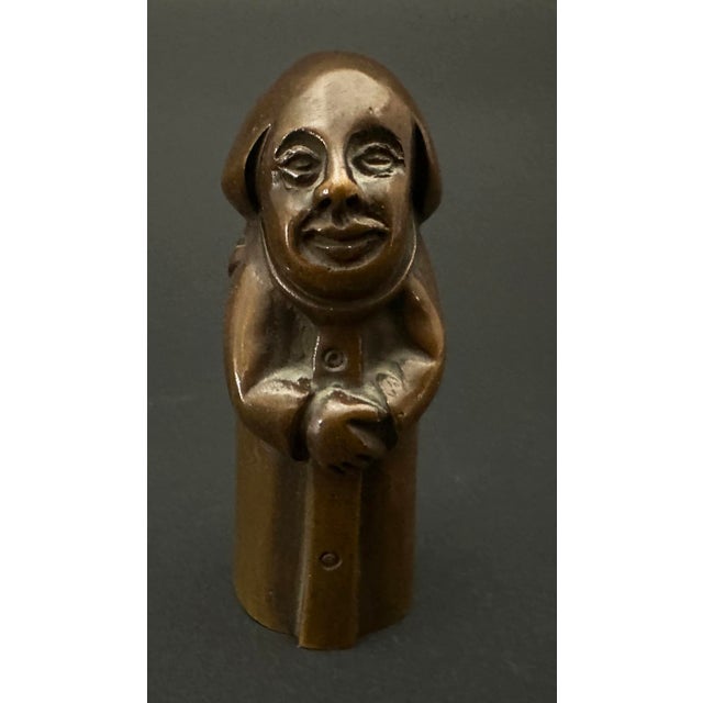 Of unknown origin, this small bronze sculpture depicts a monk. He stands enrobed, on his face a neutral expression and his...