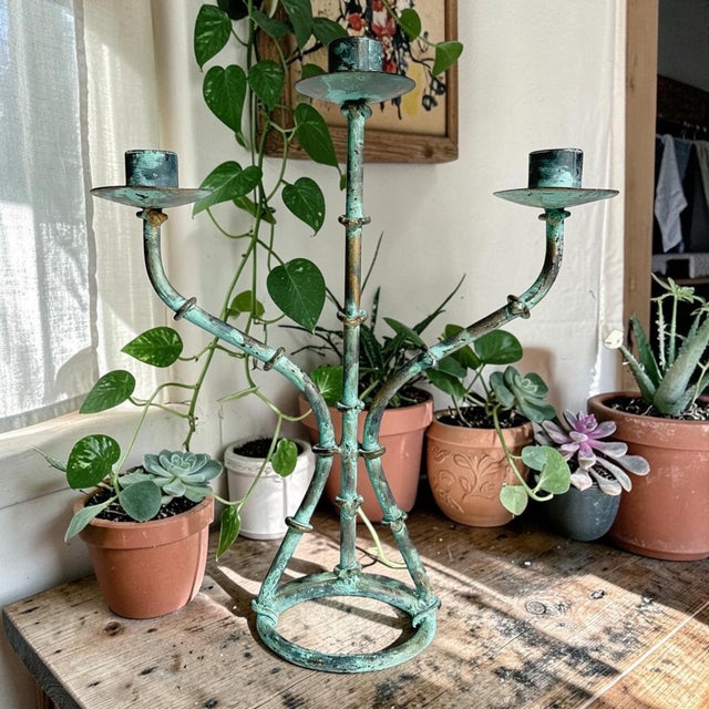 Elevate your home decor with the Rustic Metal Bamboo Verdigris 3-Arm Candelabra, a stunning centerpiece that combines...