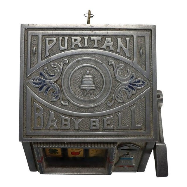 Puritan Baby Bell 5-cent mechanical trade stimulator slot machine, a 20th-century gambling collectible with a cast-metal...