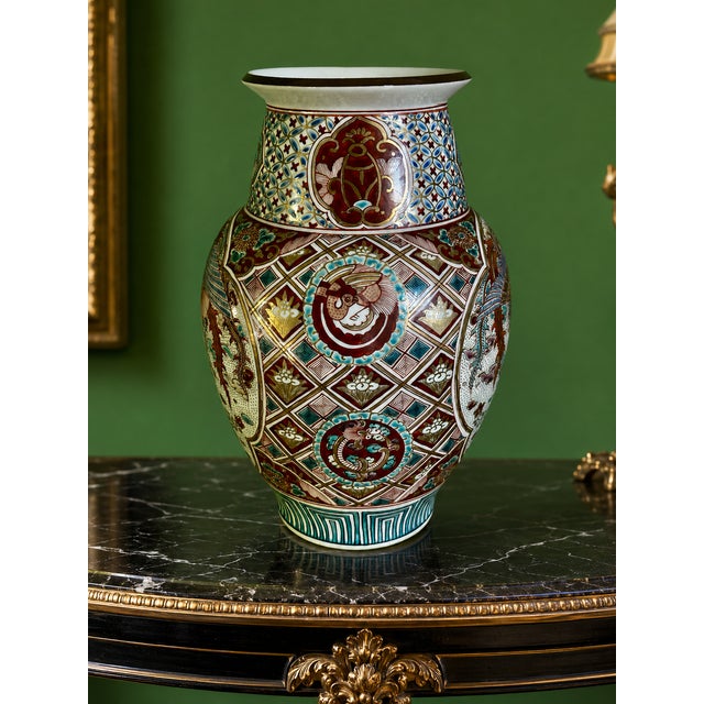 A remarkable Japanese Kutani porcelain phoenix vase dating to the late 19th-century Meiji period (1868–1912), richly hand-...