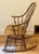 Ethan Allen Windsor-style Bowback Rocking Chair Features a curved top rail, turned spindles, and sculpted sculpted seat....