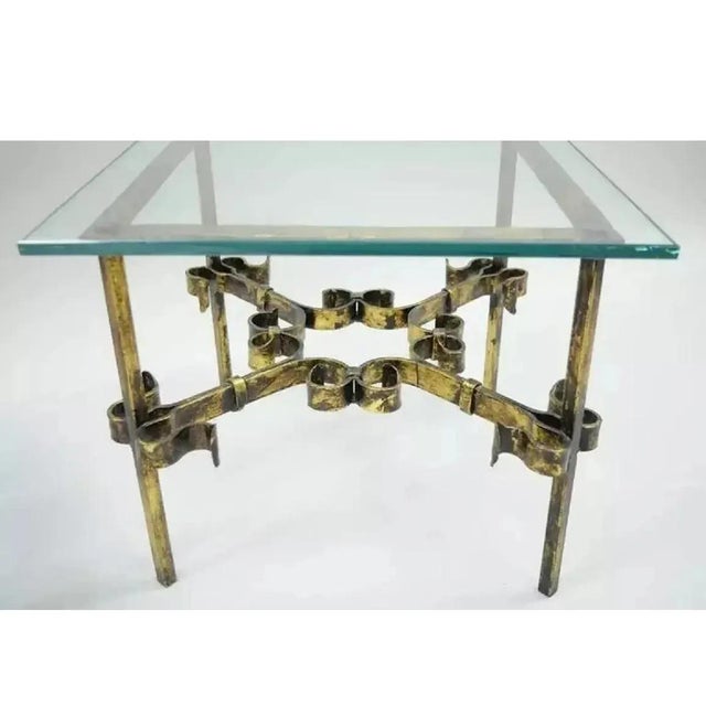 A beautifully crafted example of mid-20th-century Spanish ironwork, this wrought and gilt-iron coffee table combines...