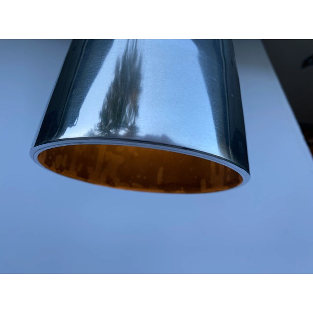 Vintage mid century cast aluminum conical pendant light that has been professionally polished and rewired. Measures 12"...