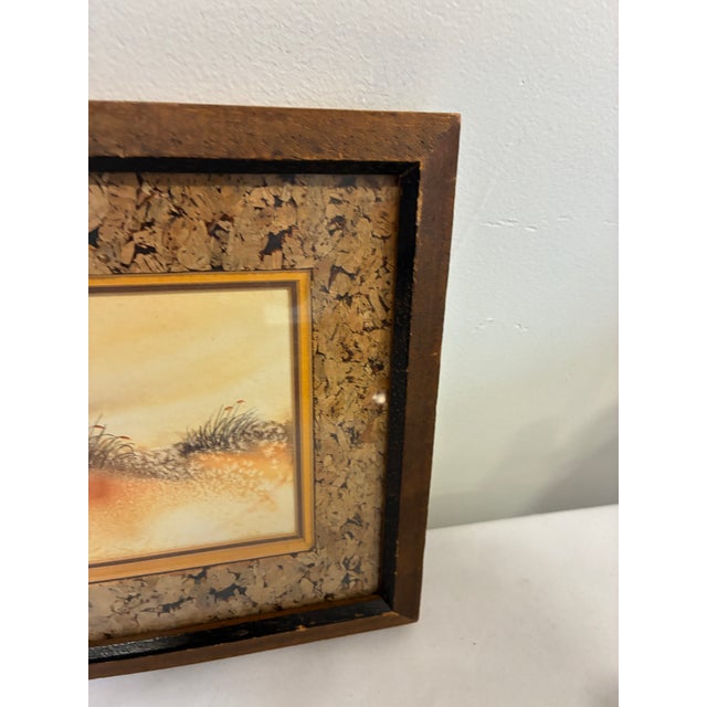 A charming vintage coastal landscape artwork featuring dunes, grasses, birds, and a glowing sunset horizon. The soft...