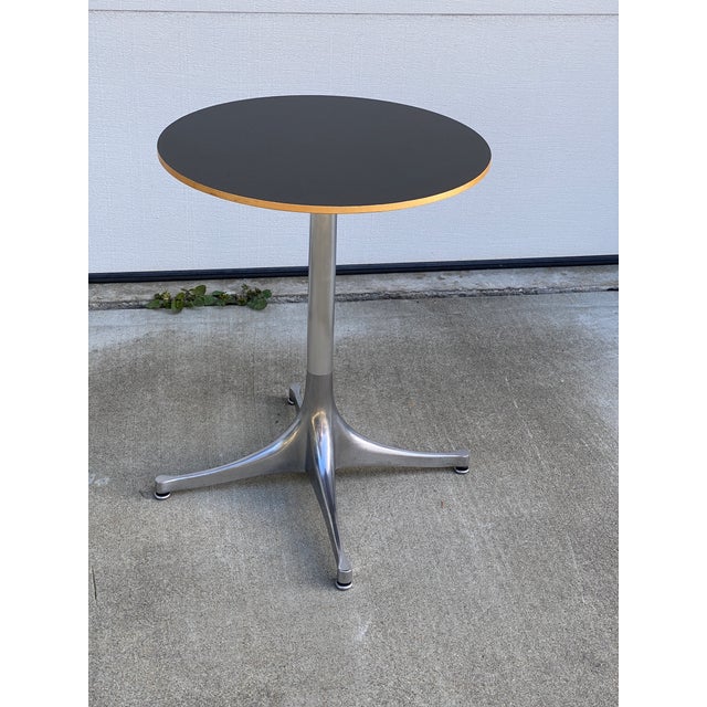 George Nelson pedestal table for Herman Miller. Polished aluminum base with black laminate top. Vintage 2008, excellent...