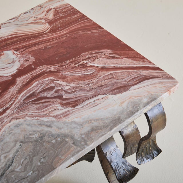 This 19th-century Spanish coffee table pays homage to old-world craftsmanship. Its hand-forged wrought iron base features...