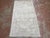 Vintage Turkish rug, hand-knotted in Turkey from 100% wool. Measuring 4’1” x 7’3”, the rug features a subtle and softly...