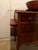 Vessel sink bowl affixed to Queen Anne style wooden cabinet with tall faucet and plumbing pipe hookup. Bowl is a deep...