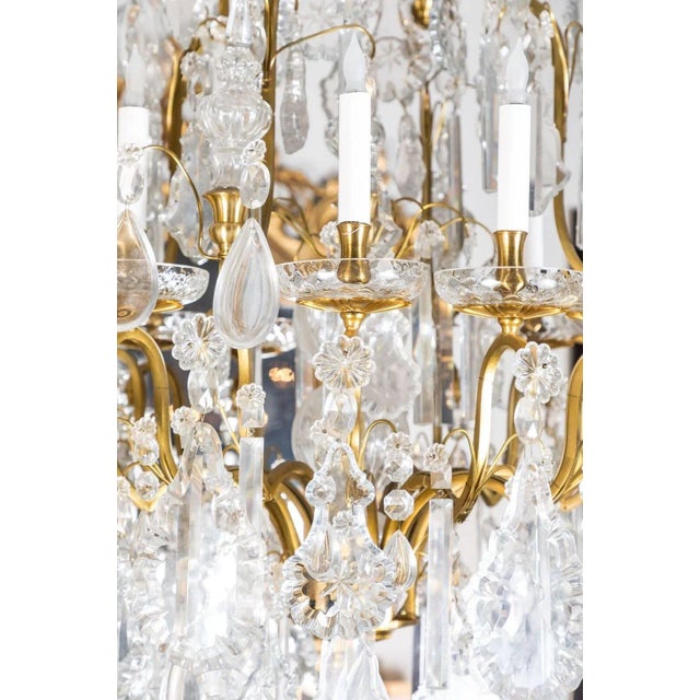 Richly embellished, large, gilt bronze and crystal, Louis XIV-style, twelve-light chandelier with a large, center tower....