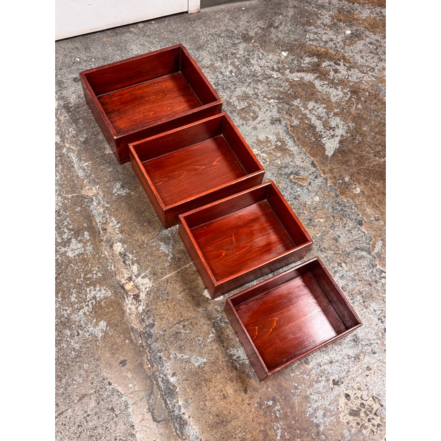 Design Plus Gallery presents a Set of Four Vintage Red Finish Wood Nesting Tray Boxes. This graduated set includes four...
