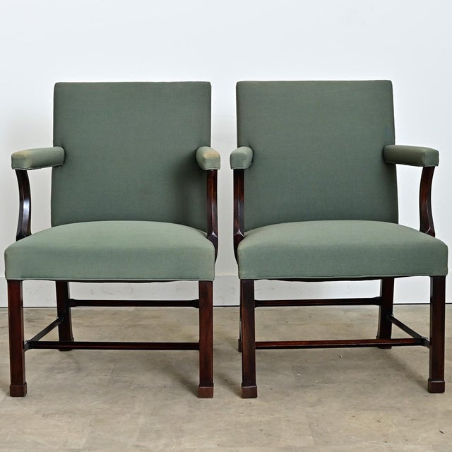 A sophisticated pair of large armchairs in the Georgian style, circa 1850, that exude a kind of regal confidence for...